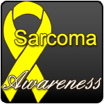 A yellow ribbon on a grey background with the words "Sarcoma Awareness" in the forefront.