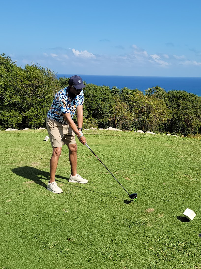 John playing golf.