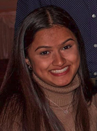 Mahi Patel smiling with another person in a blue shirt standing behind her