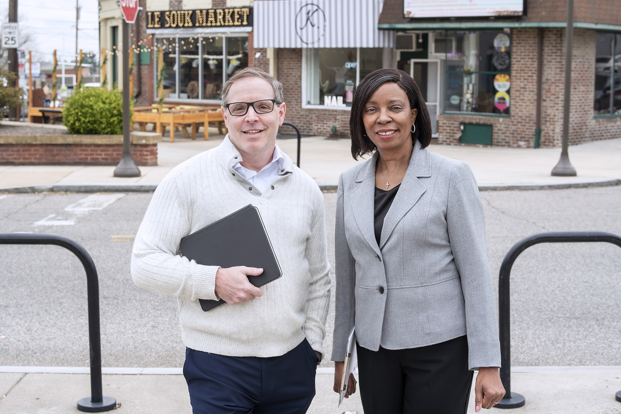 Drs. Charnita Zeigler-Johnson and Kevin Henry standing on a street