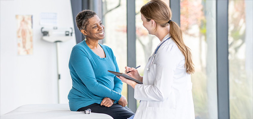 Breast cancer patient talking with doctor