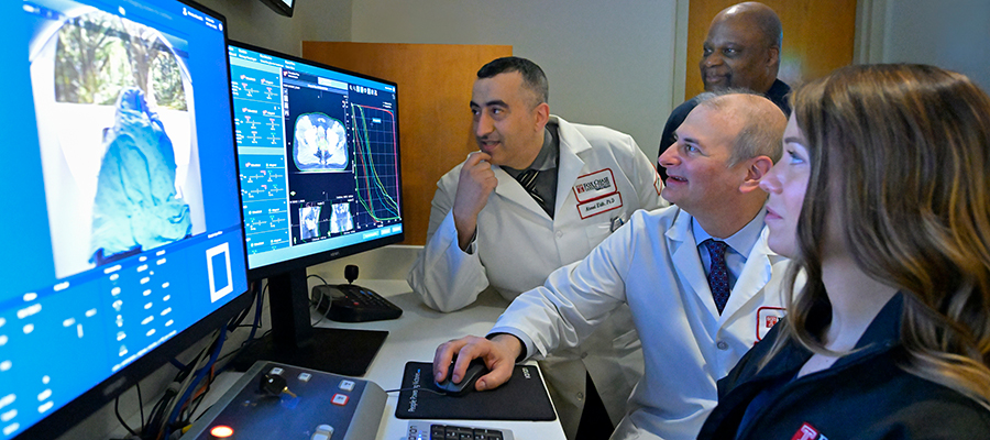 Fox Chase Cancer Center radiation oncology team reviews adaptive radiation therapy CT scans to plan more precise cancer treatments.