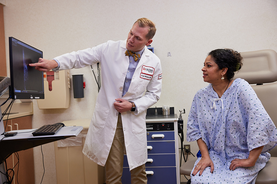 Dr. Austin Williams reviewing scans with a patient, providing compassionate care every step of the way.