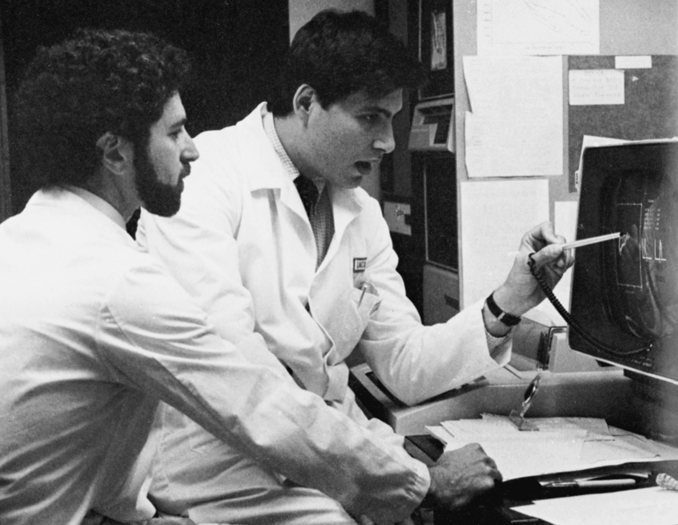 Two professionals analyzing data together on a computer device