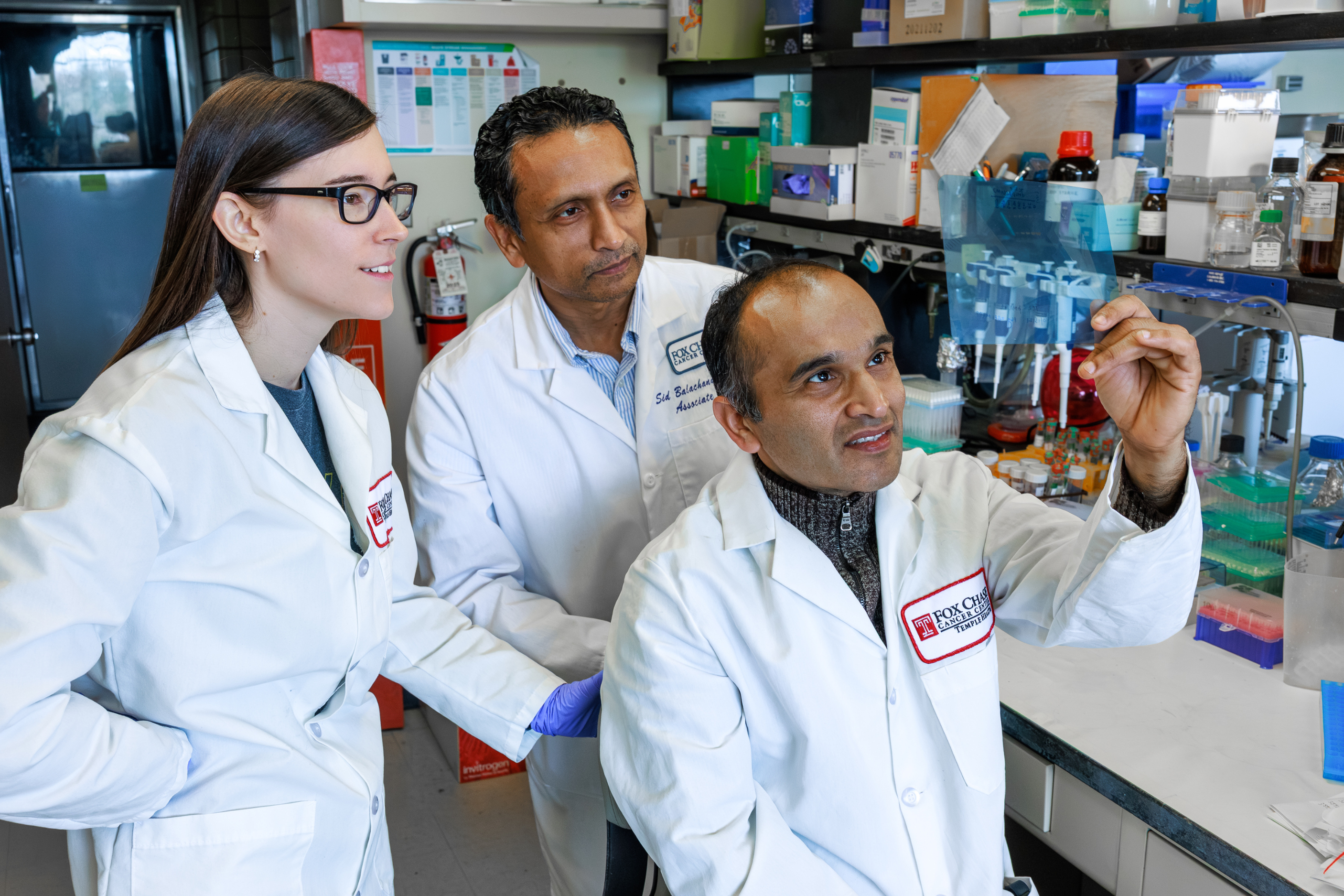 Doctors examine a specimen at Fox Chase Cancer Center.