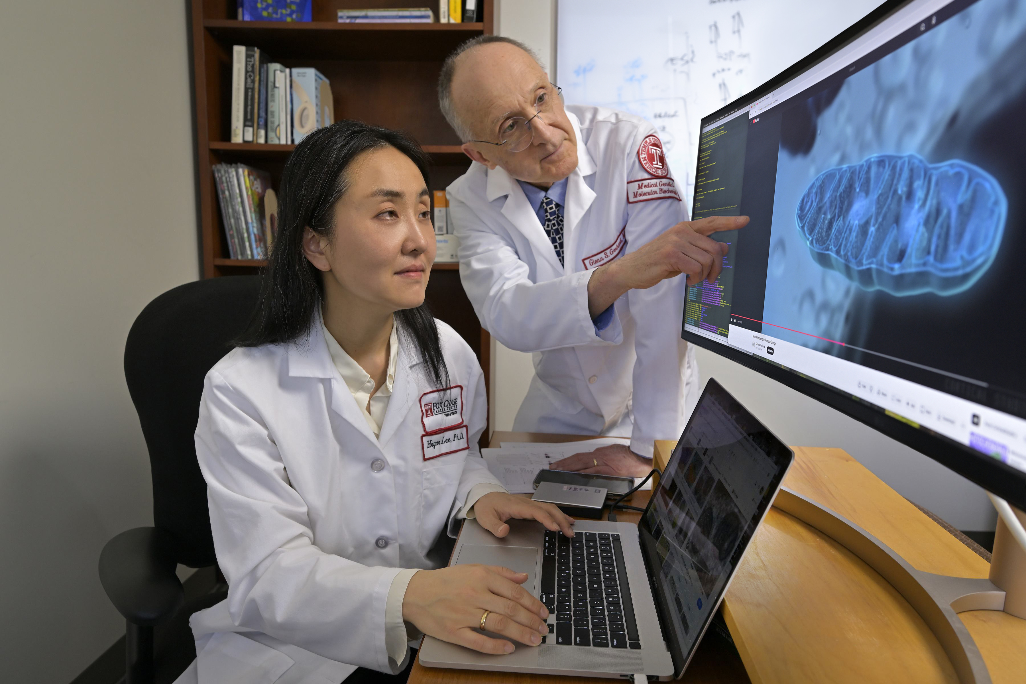 Drs Lee and Gerhard at computer with their research