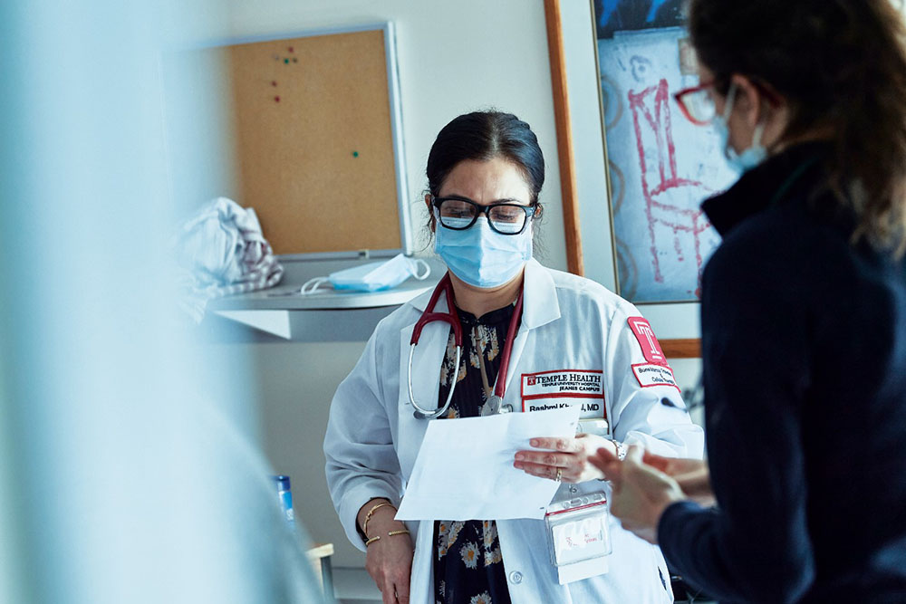 Transplant specialist Rashmi Khanal reviews a patient’s status with their nurse.