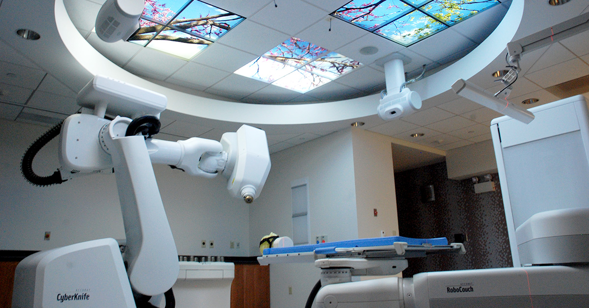 A photograph of a medical room with high tech radiation treatment machines.