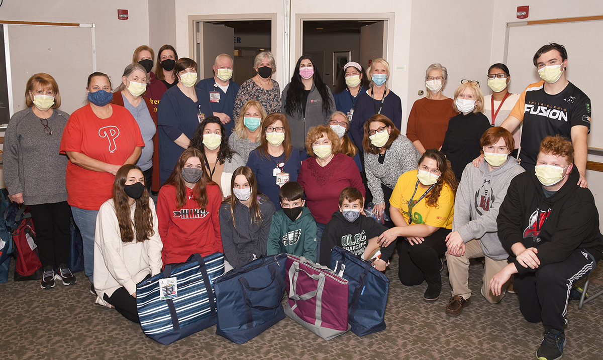 A group of nurses and volunteers of different ages with bags