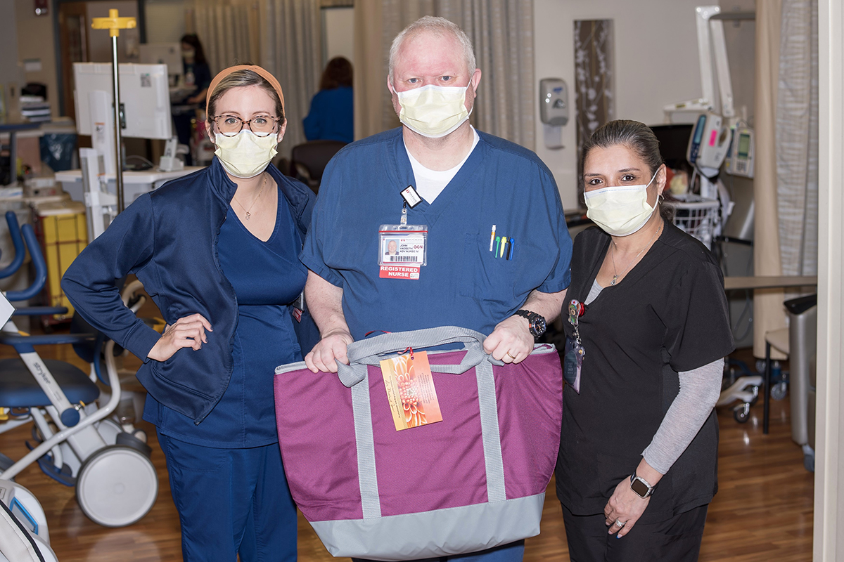 A group of nurses and volunteers of different ages with bags