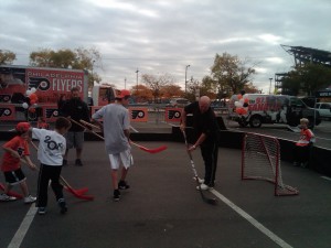 Flyers alumni, Bob Kelly, shoots with the kids.