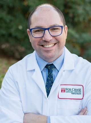 A portrait shot of Dr. Jeffrey Farma, MD, FACS, standing outside and smiling at the camera.