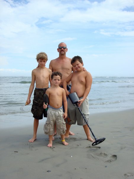 Robert enjoying a beach day with his three sons.