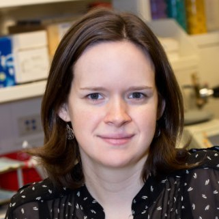 A portrait shot of Jessica Wagner in a laboratory, smiling at the camera.