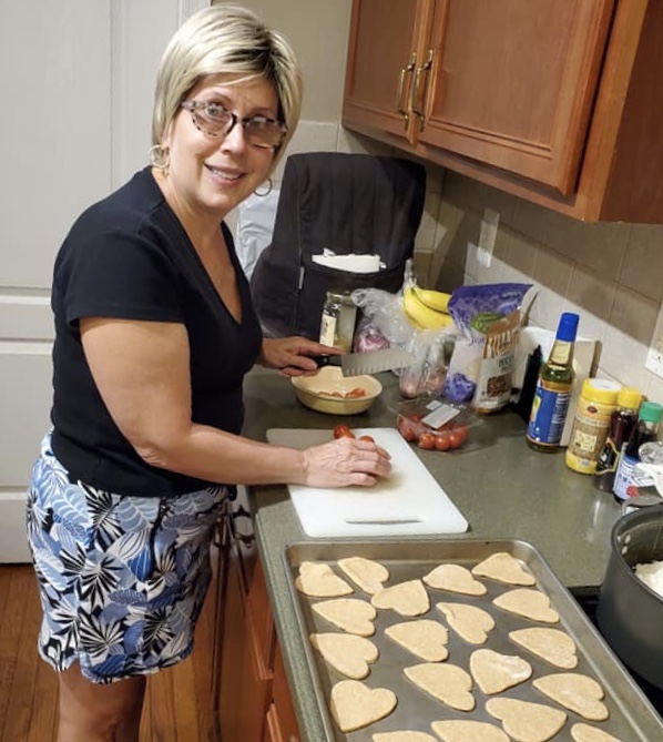 Deborah Matzura-Wolfe cooking in her kitchen.