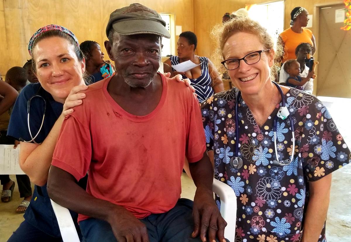 Fox Chase Cancer Center nurses, Nicole Seeley and Sandi Wetherbee, with patient at medical clinic in Port-Au-Prince, Haiti