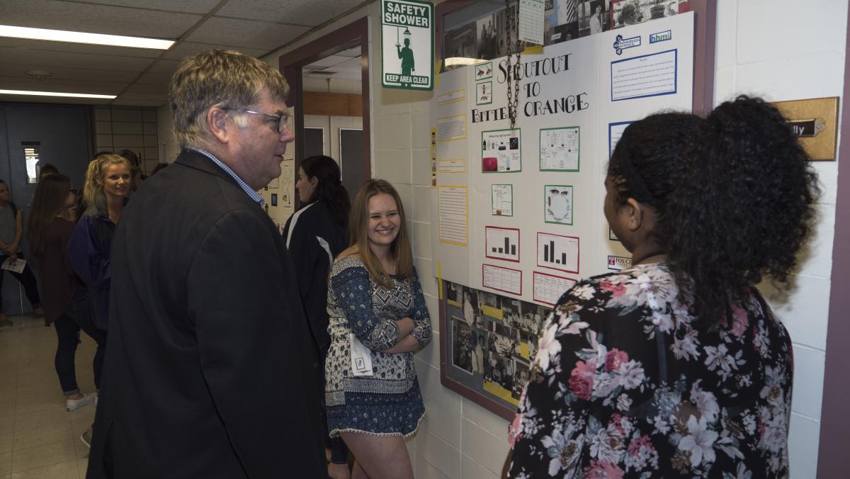 Students present their poster to Dr. Beck, chief academic officer at Fox Chase