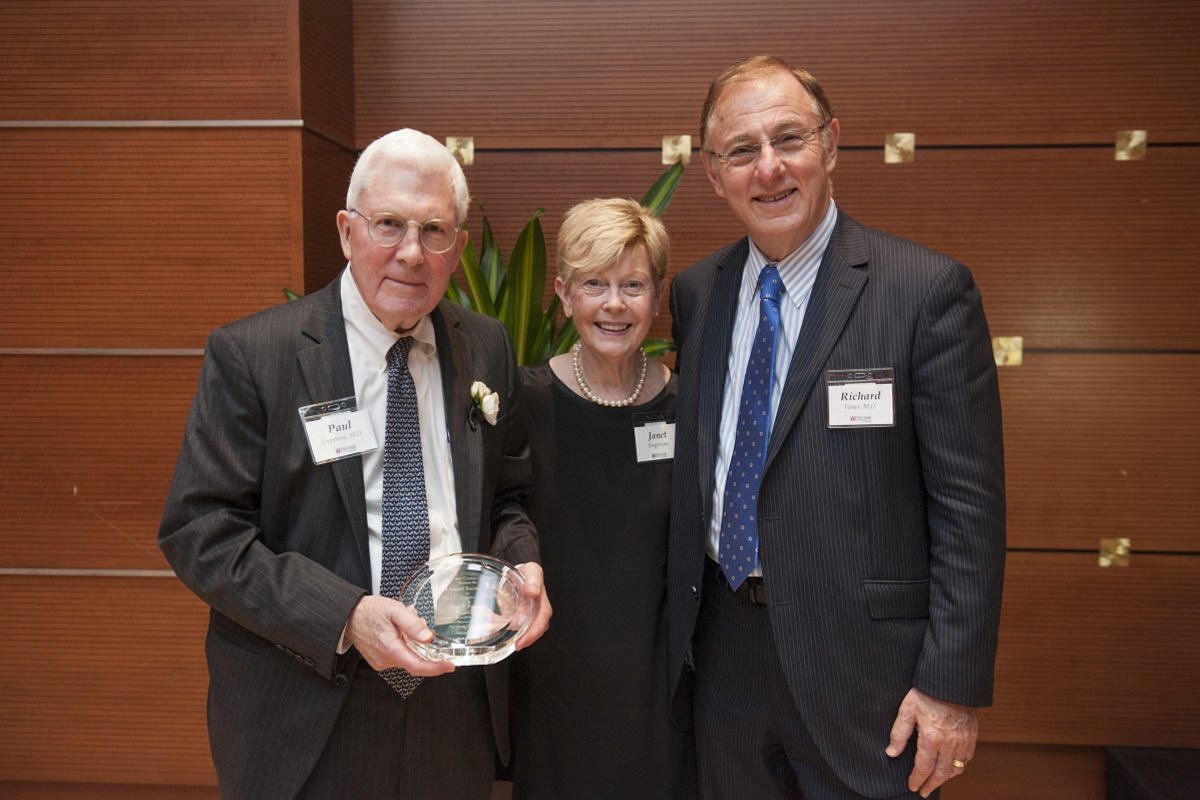 Paul Engstrom, MD, (left) and his wife Janet were honored for their combined 80 years of service to the Center.  Also pictured: Dr. Richard I. Fisher.