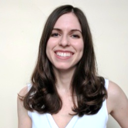 A portrait shot of Marie Danielle Ralff on a white background, smiling at the camera.