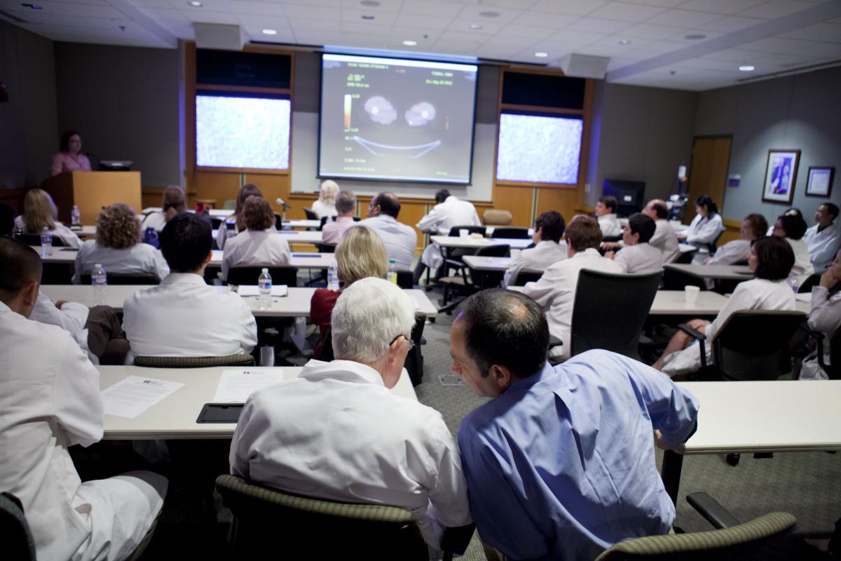 Hossein Borghaei, DO, MS, a graduate of the Fox Chase Cancer Center Hematology/Oncology Fellowship Training Program, discusses a case with Paul F. Engstrom, MD, FACP, at a tumor board.