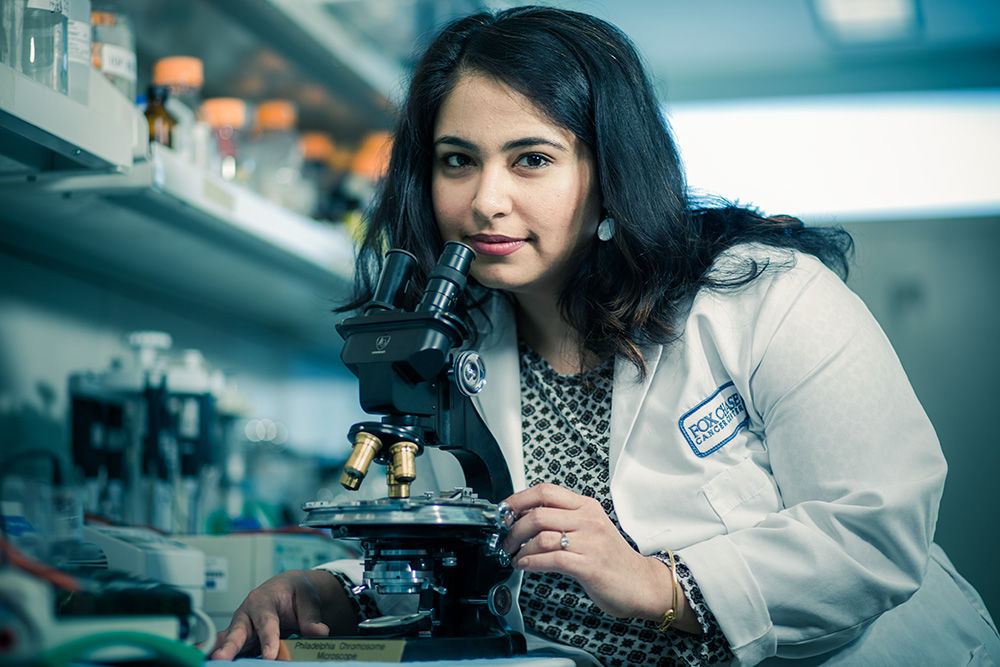 Sanjeevani Arora of the Cancer Prevention and Control Program is researching the effectiveness of treatments for colorectal cancer. She is shown here at the microscope used to identify the Philadelphia chromosome at Fox Chase in 1959, the first conclusive evidence linking cancer and genetics.