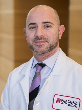 A portrait shot of Dr. Elias Obeid, MD, MPH, smiling at the camera.