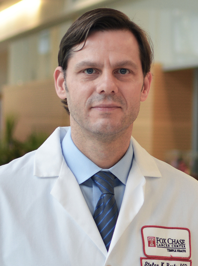 A portrait shot of Dr. Stefan Barta on a blurred background.