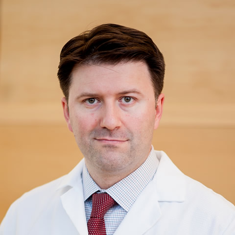 A portrait shot of Dr. Alexander Kutikov, MD, FACS, looking at the camera with a small smile.