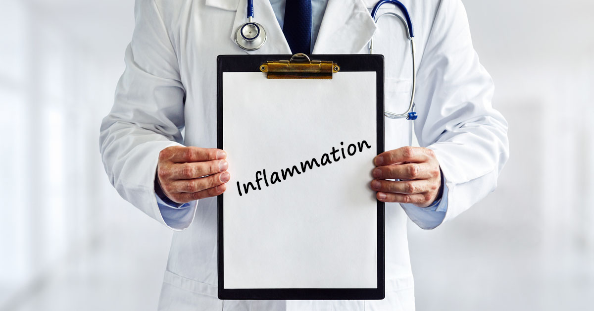 A physician wearing a lab coat, holding a clipboard that reads, "inflammation."