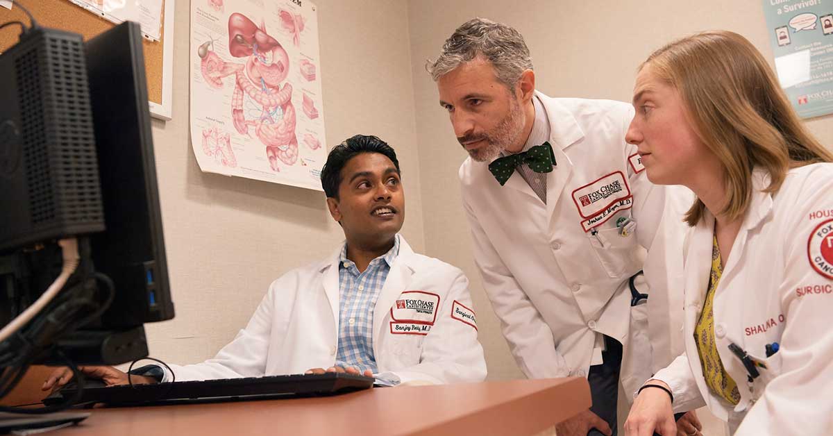 Joshua E. Meyer, MD (middle) works with a multidisciplinary team to find the right radiation therapy for patients with pancreatic cancer.  