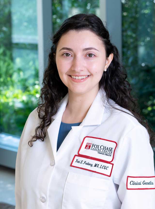 Yael Freiberg, a clinical genetics at Fox Chase, wearing white coat and smiling