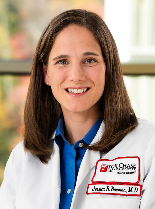 Jessica Bauman, wearing a white coat and smiling