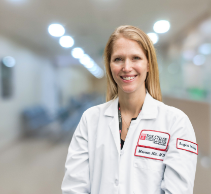Maureen V. Hill standing in the hospital hallway.