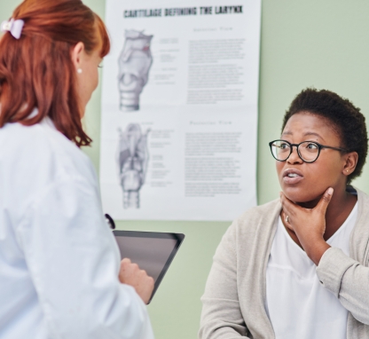 Doctor examing woman throat during a consulation