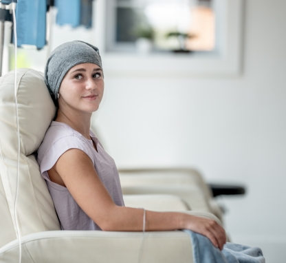 Young woman sitting in a chair recieiving a blood transfusion