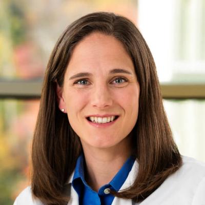 Jessica Bauman, wearing a white coat and smiling