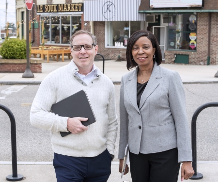 Drs. Charnita Zeigler-Johnson and Kevin Henry standing on a street