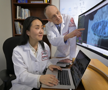 Drs Lee and Gerhard at computer with their research