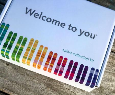 A photo of a white box with a rainbow of chromosomes along the bottom edge with the words, "Welcome to you" in the center.
