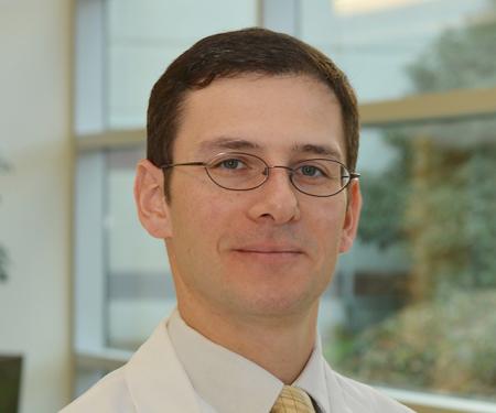 A portrait shot of Dr. Daniel M. Geynisman, MD, smiling at the camera.