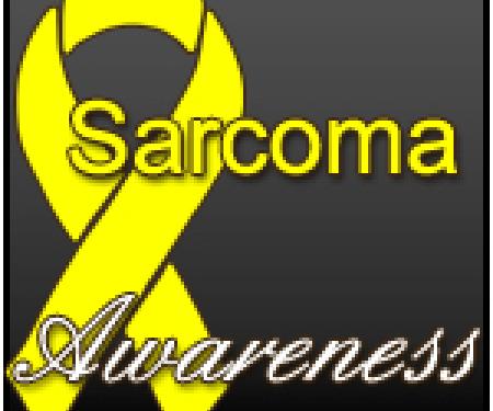 A yellow ribbon on a grey background with the words "Sarcoma Awareness" in the forefront.