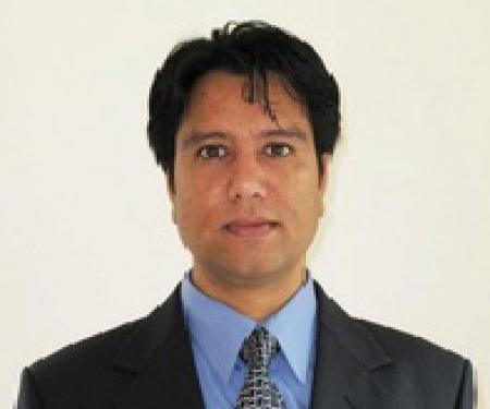 A portrait shot of Roshan Thapa, MD, with a white background.