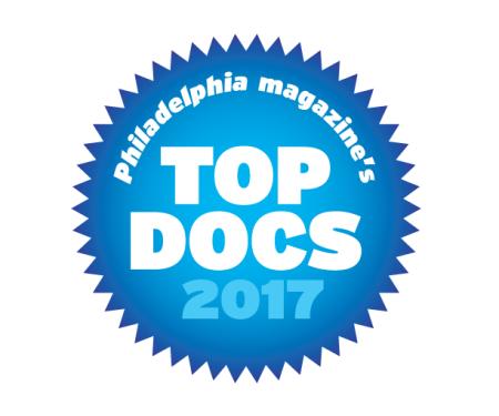 A spiky blue circle with "Philadelpha Magazine's Top Docs 2017" written inside in white.