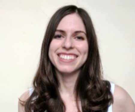 A portrait shot of Marie Danielle Ralff on a white background, smiling at the camera.