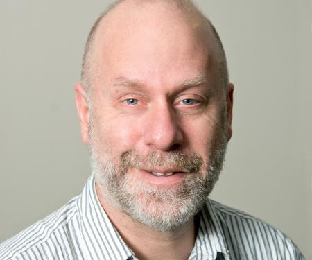 A close-up shot of Roland Dunbrack, PhD with a grayish backdrop