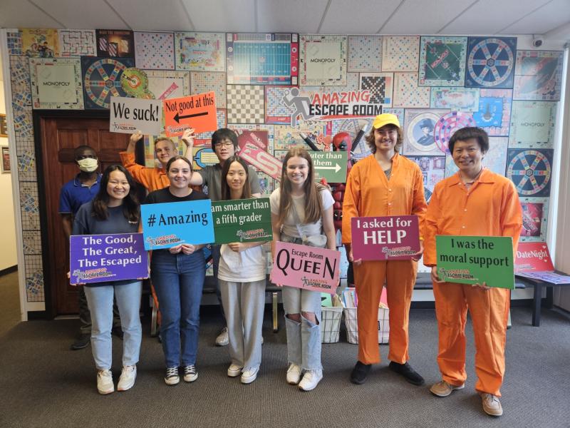 A group of students holding colorful signs