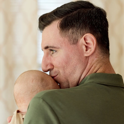 Josh Breen kissing his baby