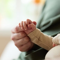 Josh holding his son's hand