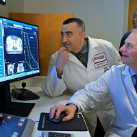 Providers examining a computer screen