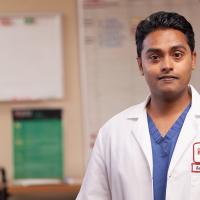 A photo of Dr. Sanjay Reddy, a pancreatic cancer surgeon at Fox Chase, standing in a medical room.